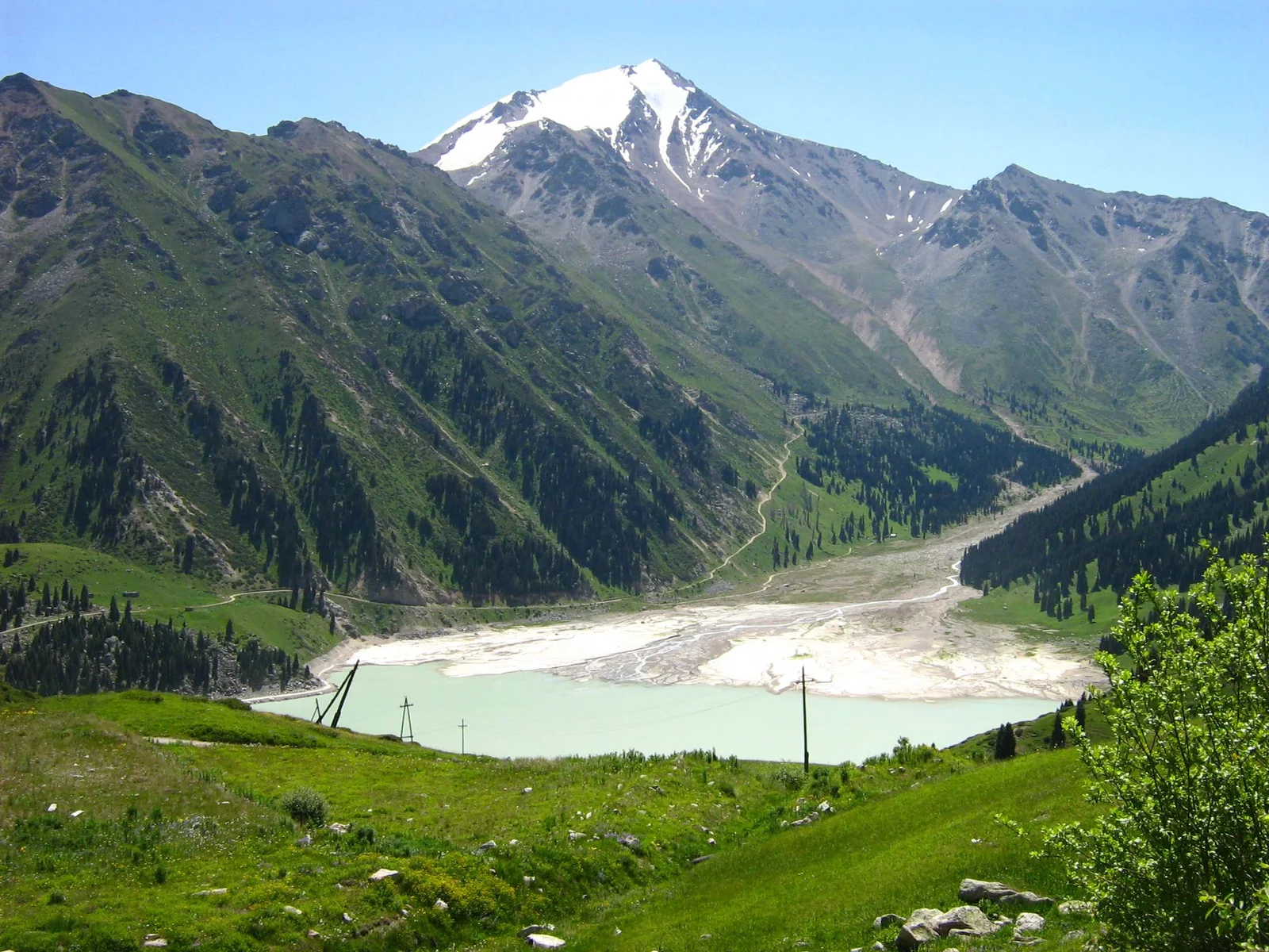 Big Almaty Lake beneath the snow-capped Trans-Ili Alatau mountains in Kazakhstan