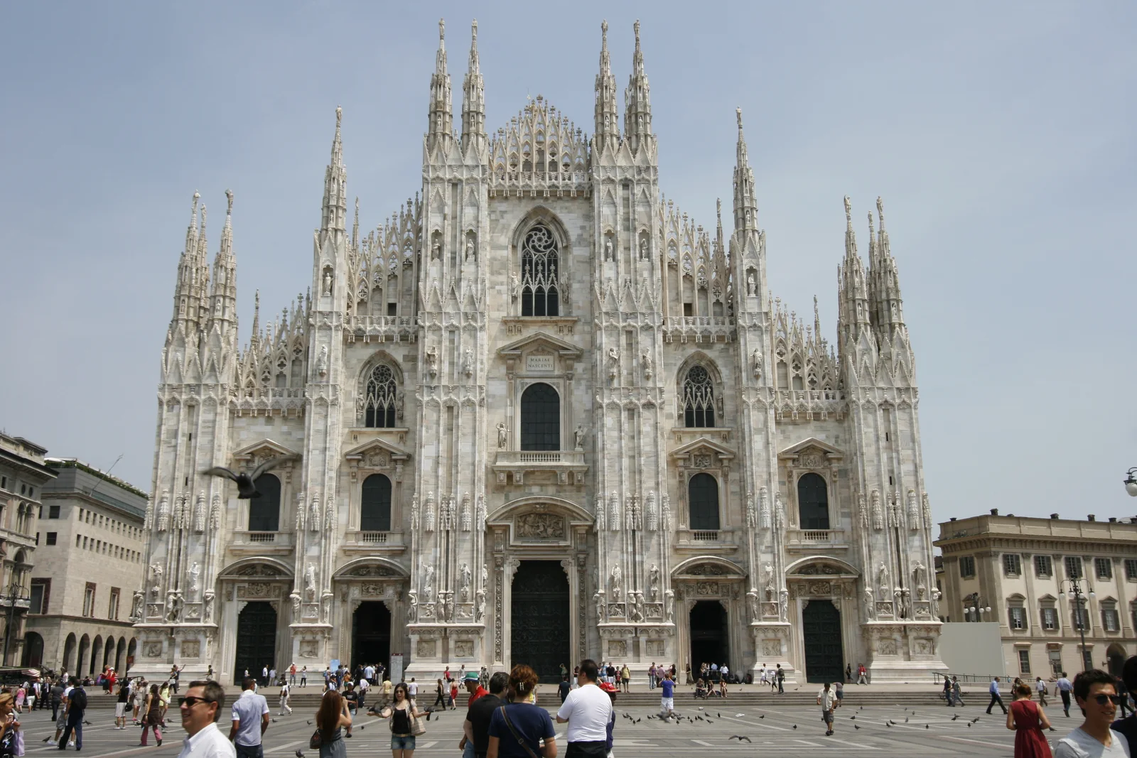 The ornate marble facade of Milan Cathedral overlooking Piazza del Duomo