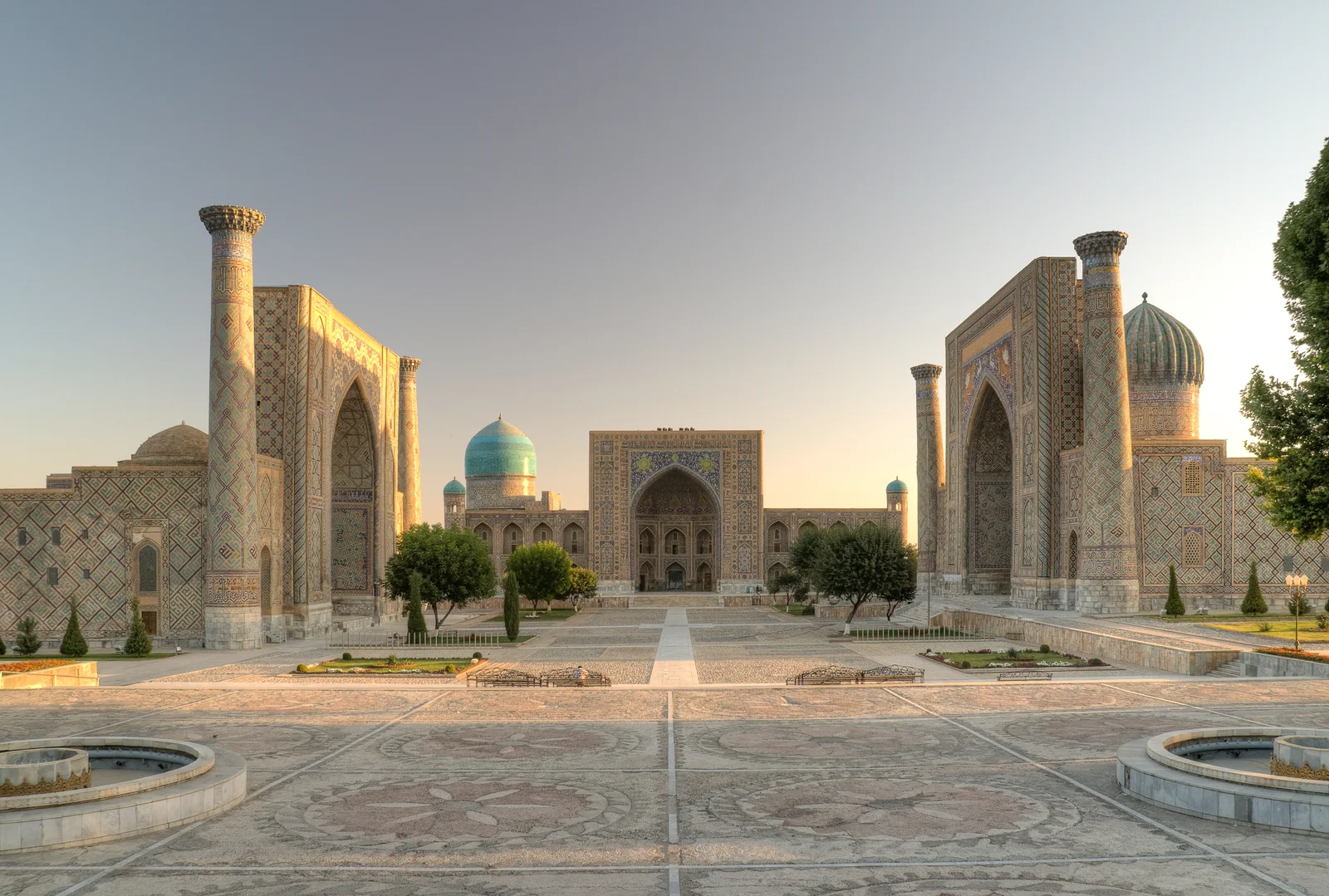 Registan Square in Samarkand with turquoise domes and ornate madrasas in the morning light