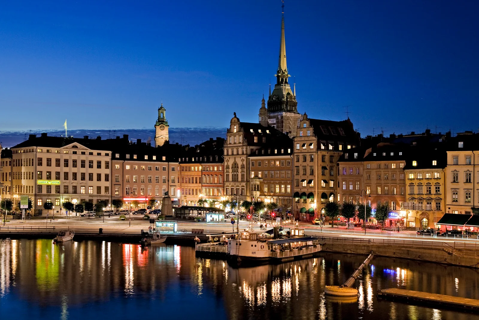 Stockholm's Gamla Stan waterfront illuminated at dusk with reflections on the water