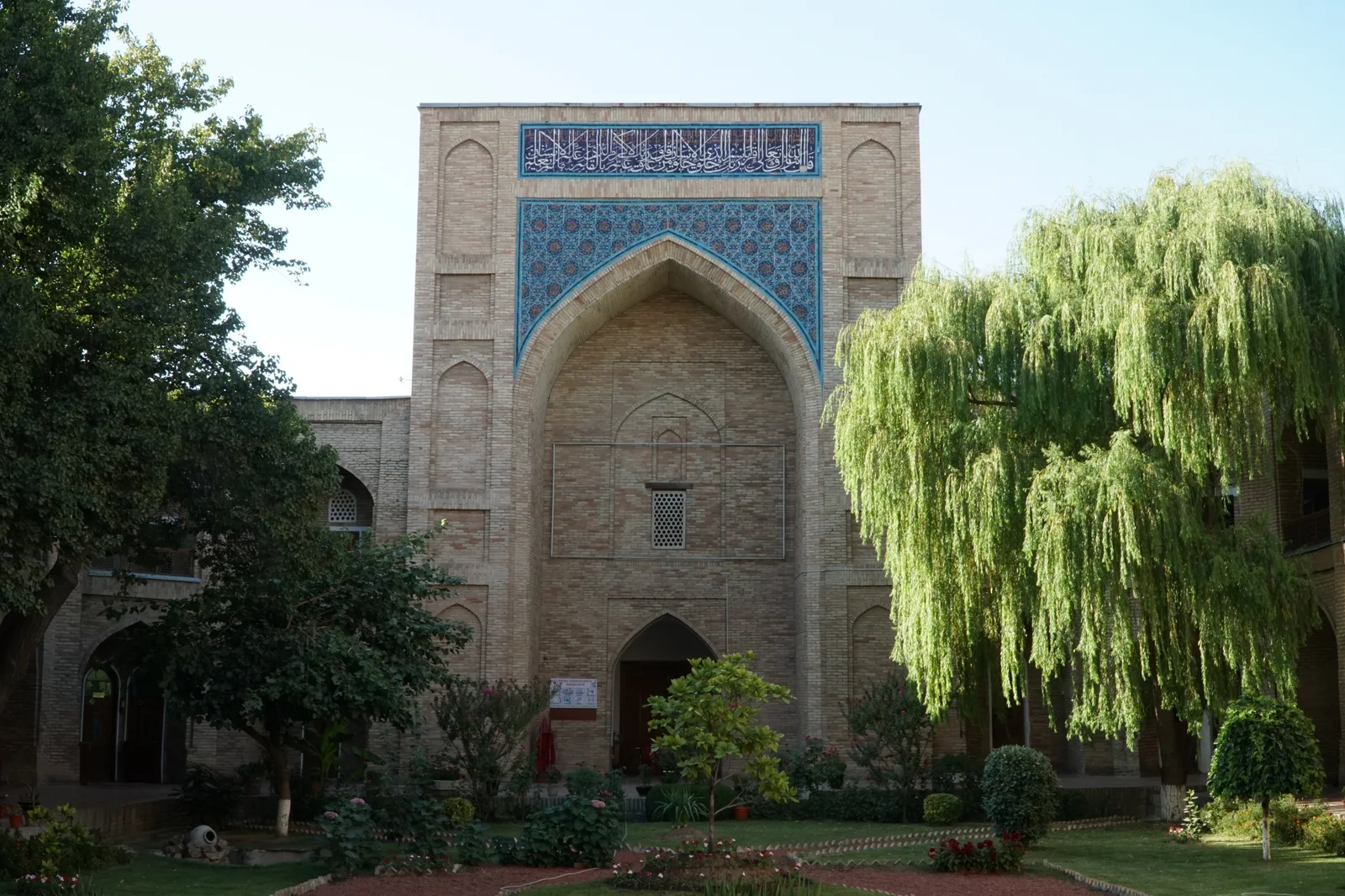 The tiled entrance and leafy courtyard of Kukeldash Madrasah in Tashkent