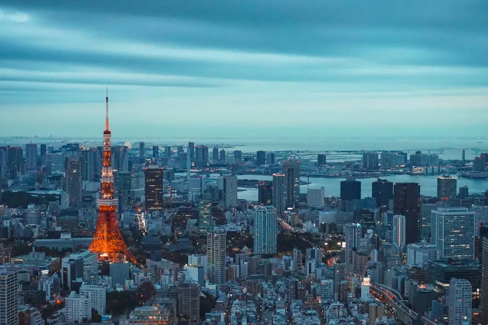 Tokyo Tower illuminated above the Tokyo skyline at dusk